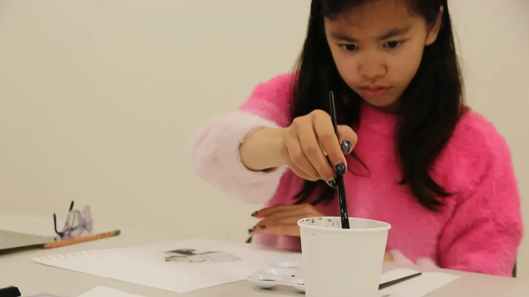 Girl drawing with ink